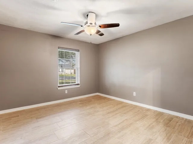 wooden floor in an empty room with a window