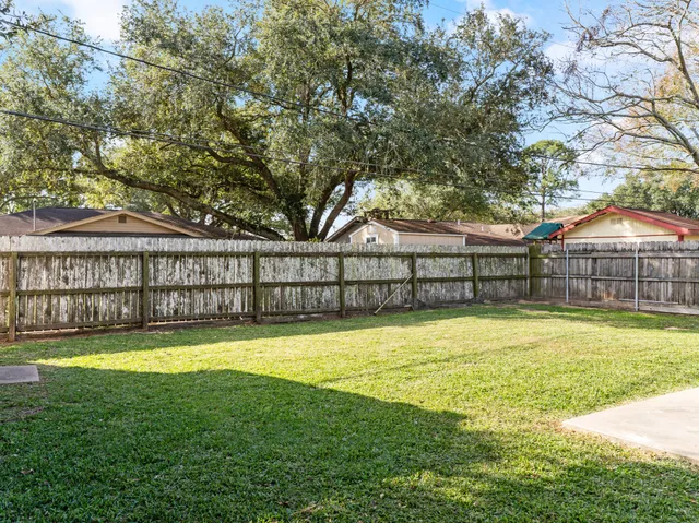 a view of a swimming pool with deck and a big yard
