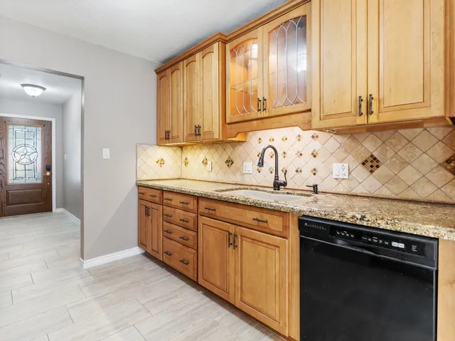 a kitchen with stainless steel appliances granite countertop a sink stove and cabinets