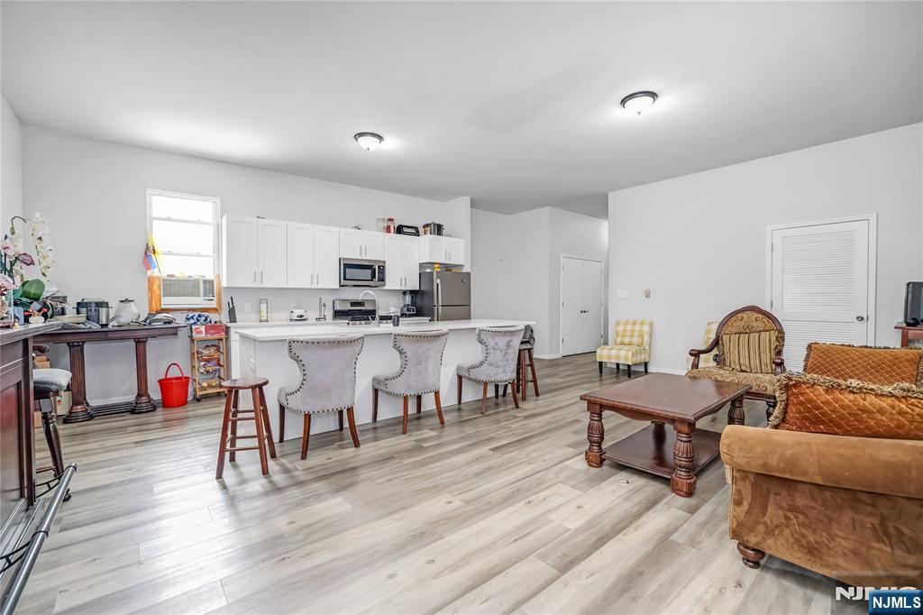 512 Monastery Place, Unit 3 Union City, NJ 07087 - Photo 3 of 11 a living room with lots of furniture and kitchen view