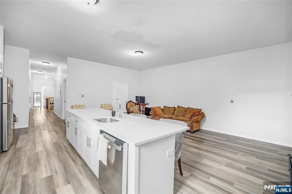 512 Monastery Place, Unit 3 Union City, NJ 07087 - Photo 5 of 11 a view of a kitchen counter space a sink and a refrigerator