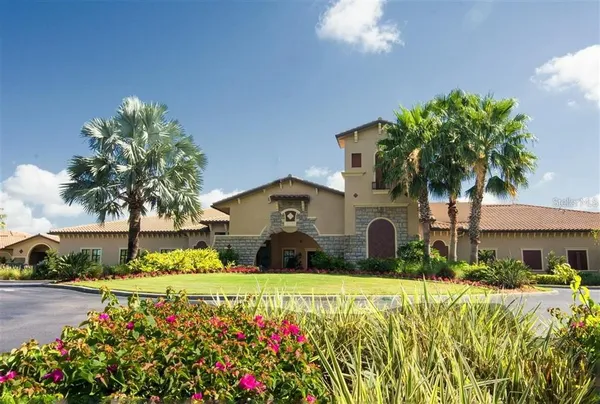 a front view of a house with a yard and fountain in middle