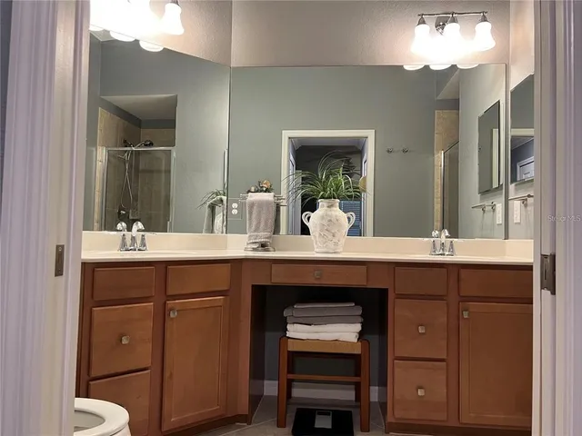 a view of bathroom with a sink and a mirror