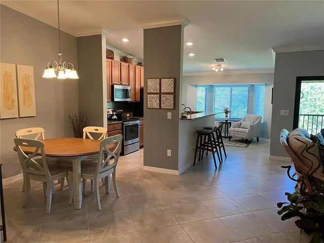 a view of a dining room with furniture and a chandelier