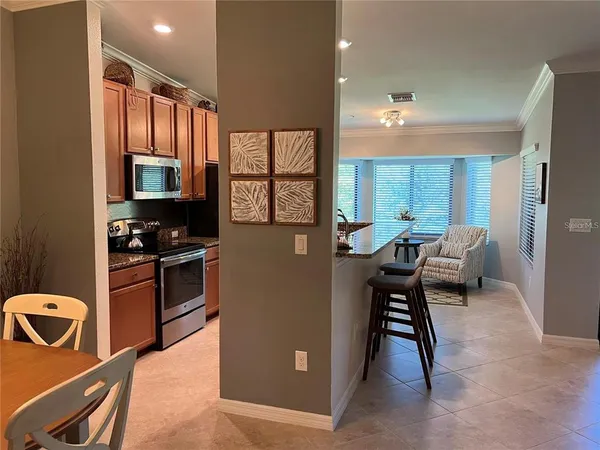 a kitchen with stainless steel appliances granite countertop a stove refrigerator sink and cabinets