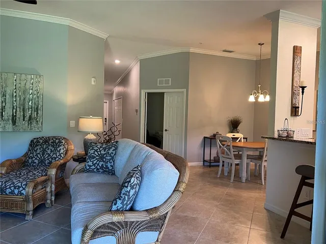 a living room with furniture and a lamp