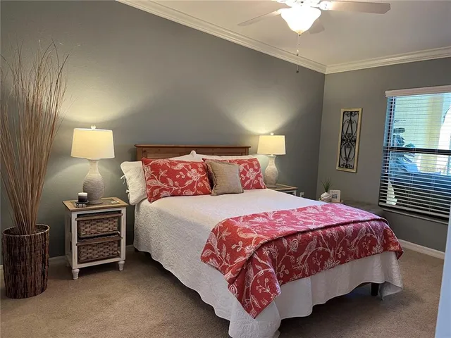 a bedroom with a bed and a lamp