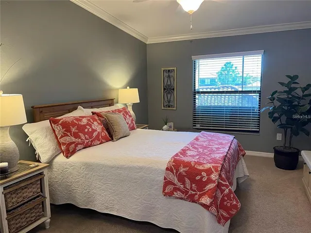 a bedroom with a bed and potted plant