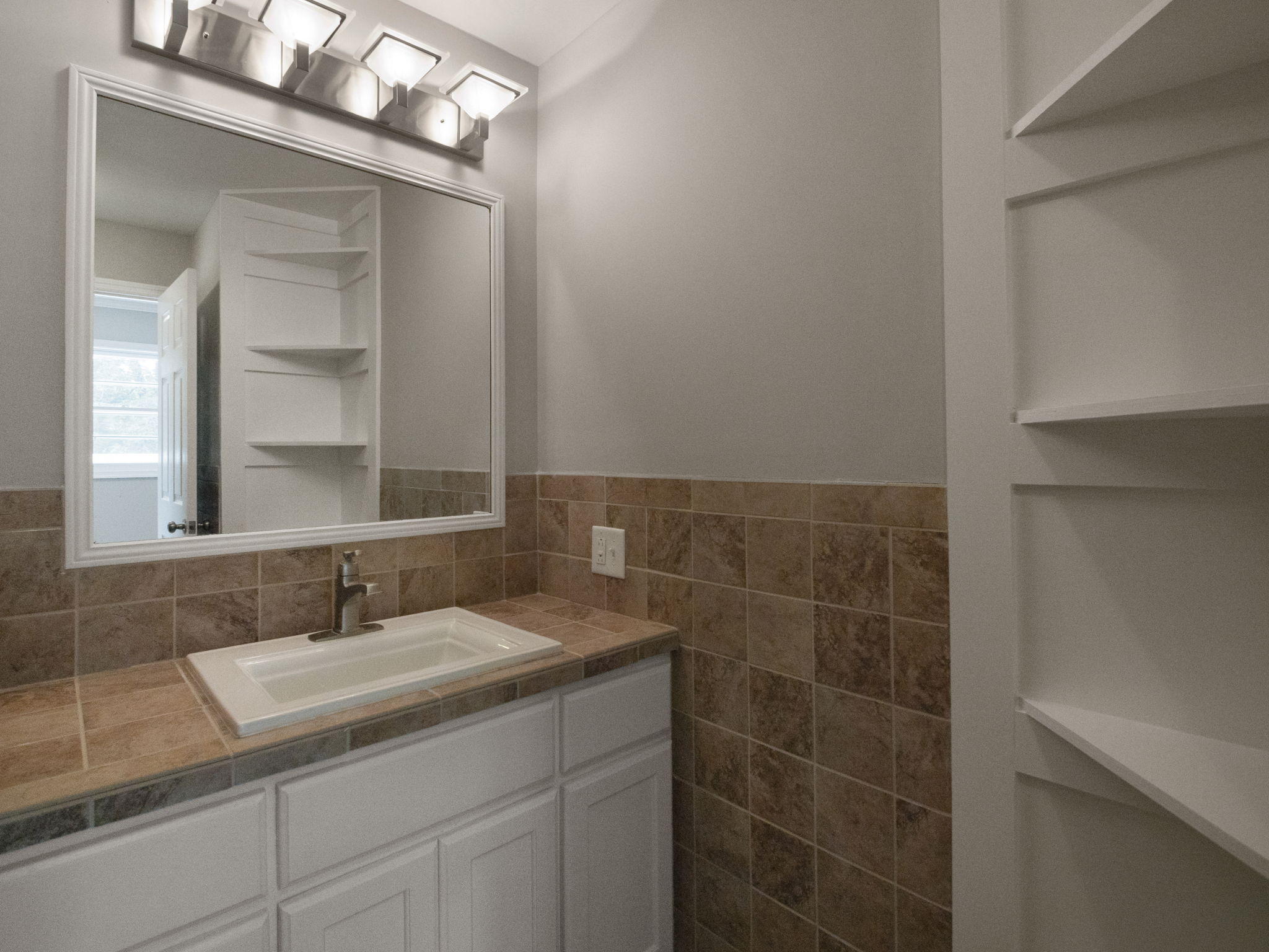 2665 Iron Ridge Road Rocky Mount, VA 24151 - Photo 14 of 26 a bathroom with a granite countertop sink a mirror and a shower