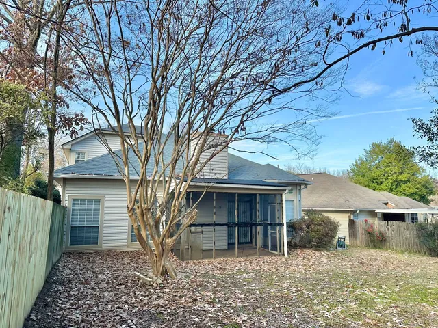 front view of a house with a large tree