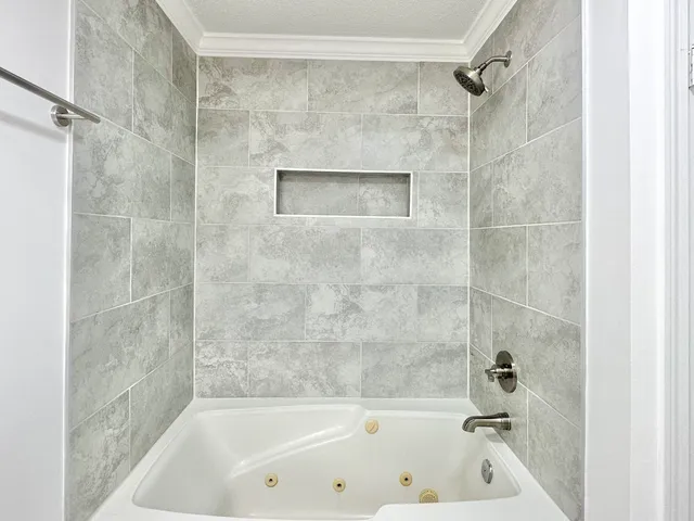 a bathroom with a bathtub and a shower