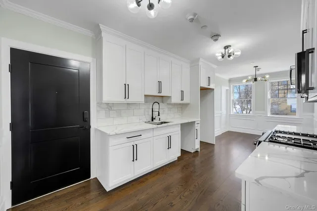 a kitchen with stainless steel appliances a sink stove and refrigerator