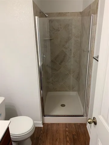 a bathroom with a shower and a toilet