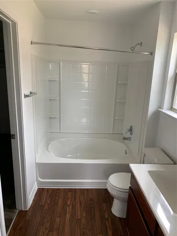 a bathroom with a toilet a sink and bathtub