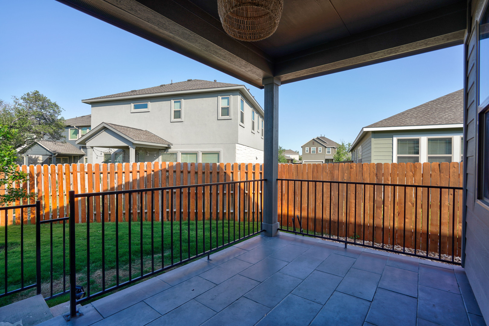 2240 Ringstaff Road Leander, TX 78641 - Photo 22 of 25 Covered patio featuring large format tile flooring and black metal railing
