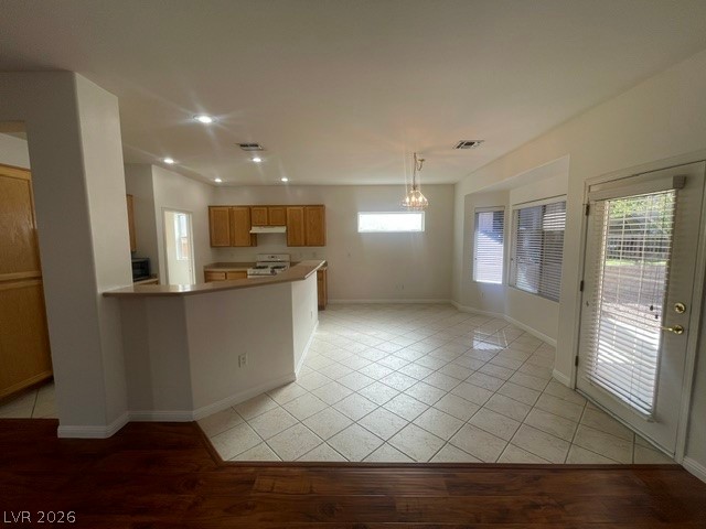 3047 Hickory Valley Road Henderson, NV 89052 - Photo 6 of 21 An inviting open-concept layout connects a spacious kitchen to a naturally lit dining area, perfect for entertaining.