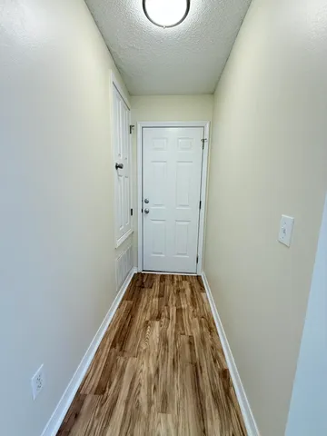a view of a room with wooden floor and bench