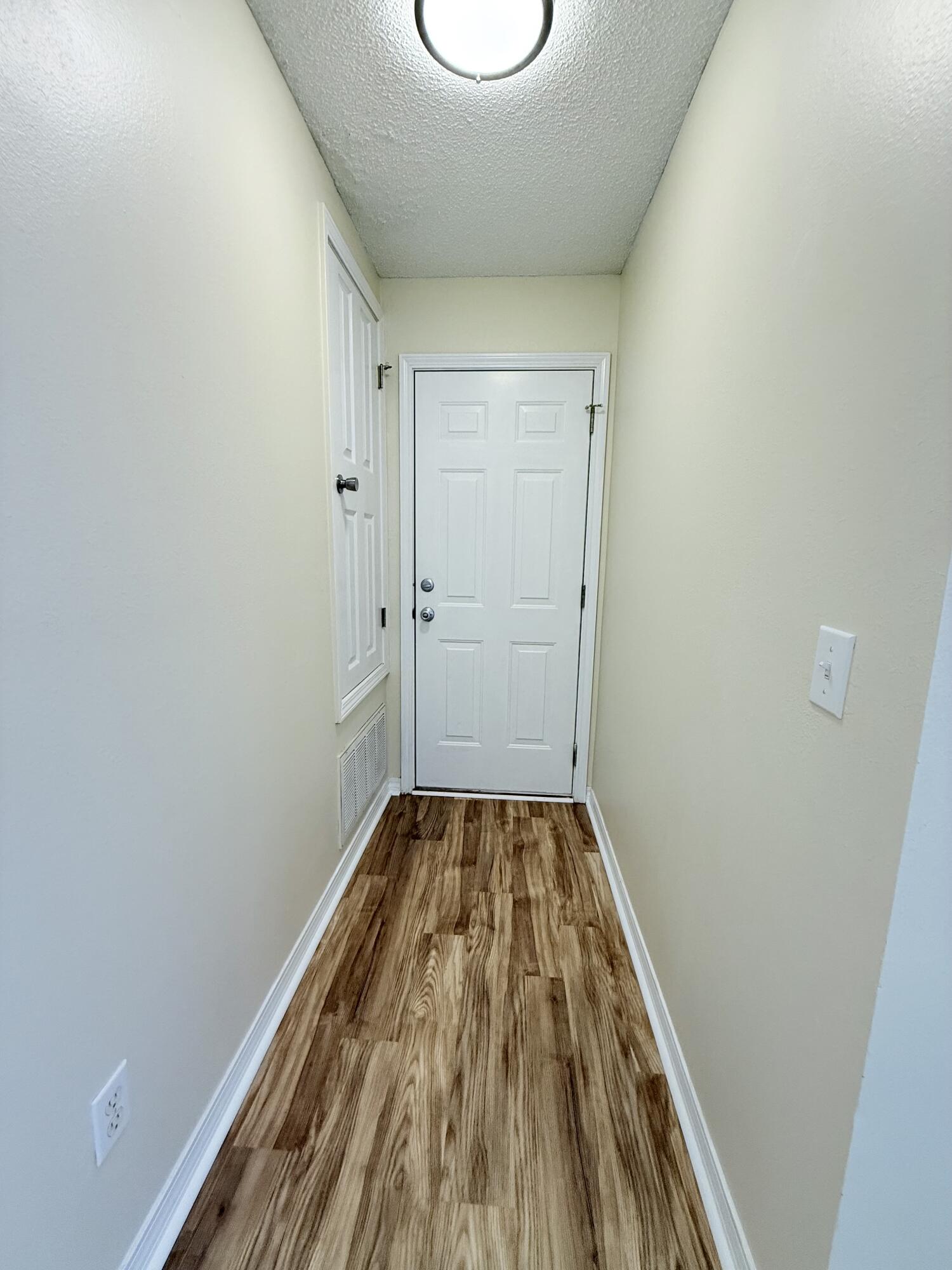7612 Chablis Circle Navarre, FL 32566 - Photo 13 of 16 a view of a room with wooden floor and bench