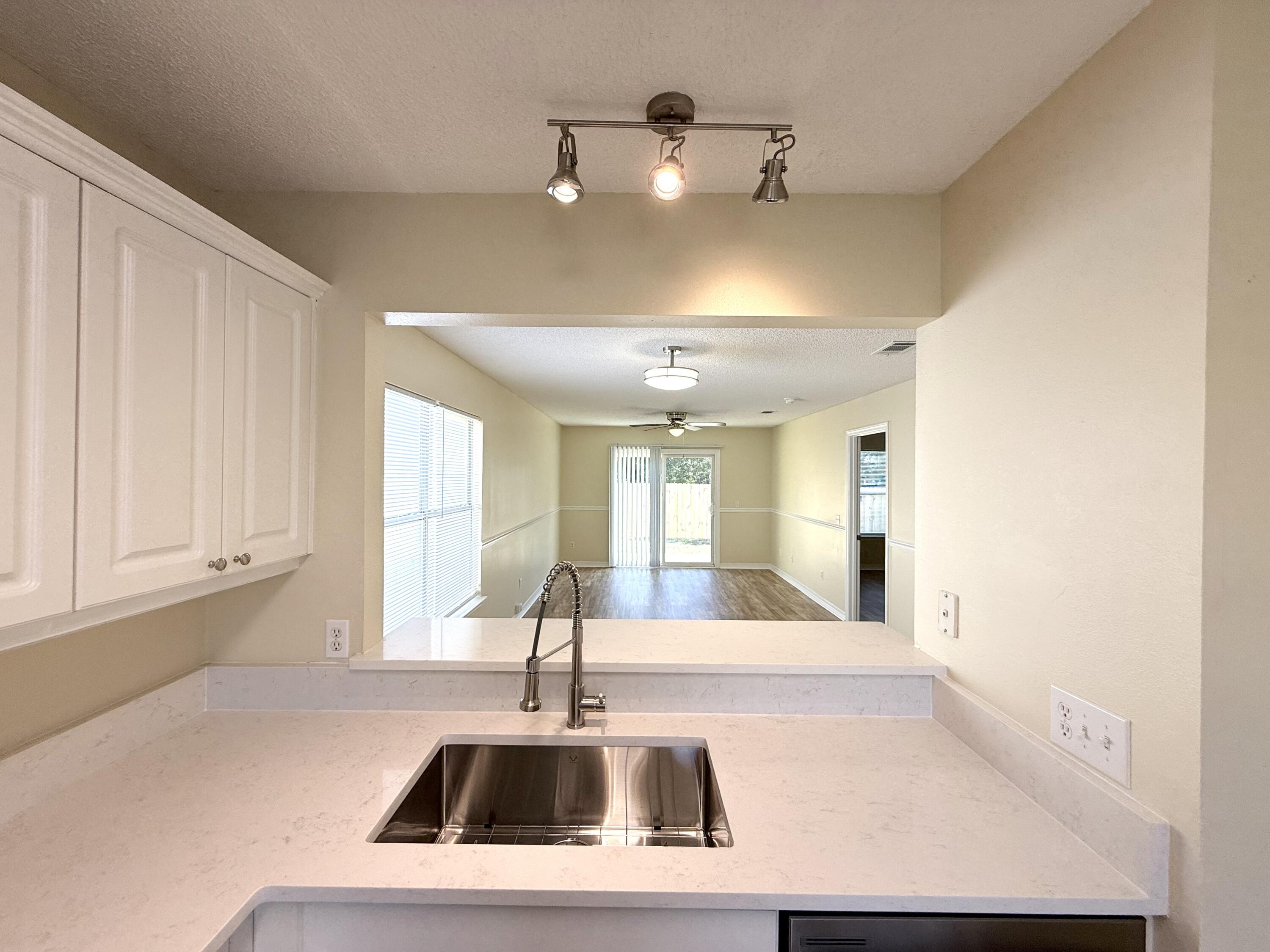 7612 Chablis Circle Navarre, FL 32566 - Photo 5 of 16 a view of kitchen with furniture and window