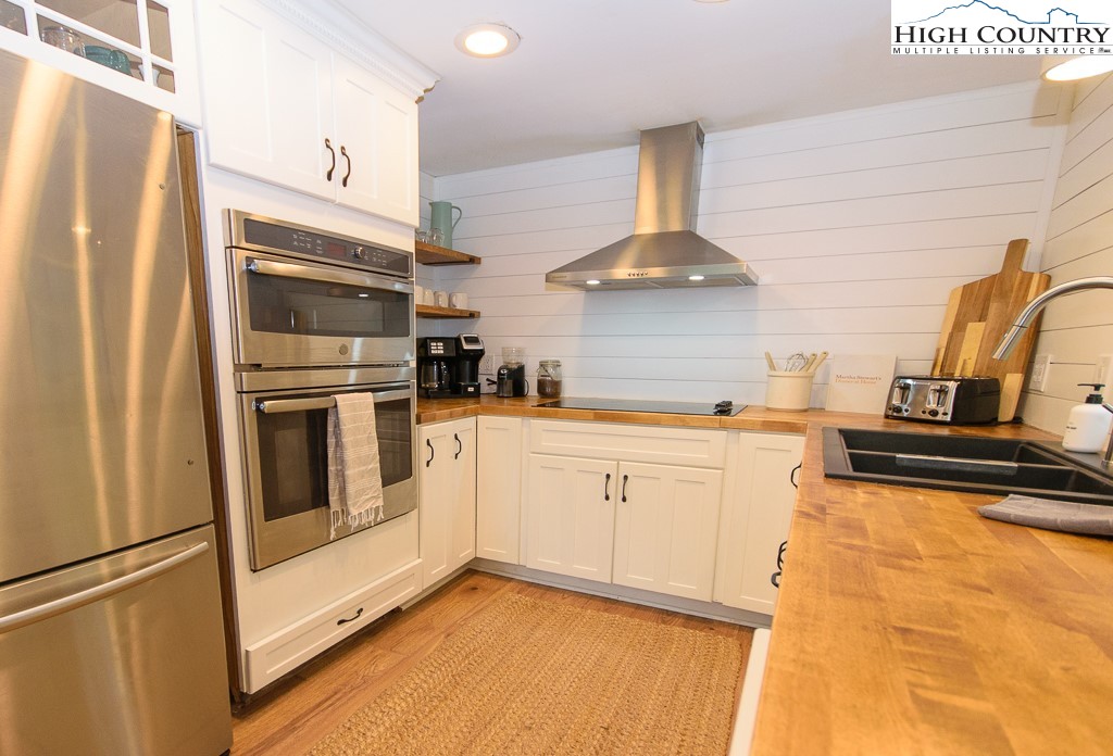 205 Spring Branch Road Beech Mountain, NC 28604 - Photo 13 of 46 a kitchen with stainless steel appliances a refrigerator stove and sink