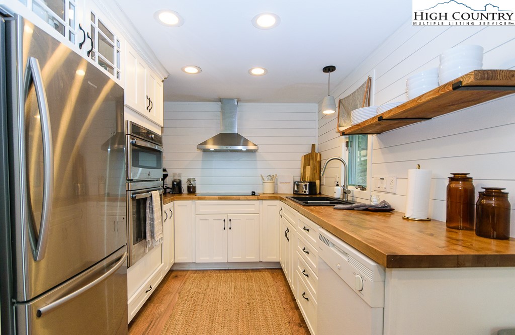 205 Spring Branch Road Beech Mountain, NC 28604 - Photo 14 of 46 a kitchen with a sink stainless steel appliances a counter top space