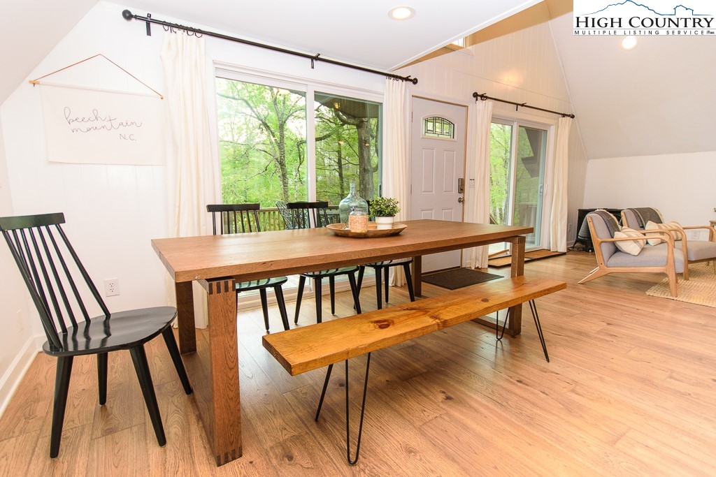205 Spring Branch Road Beech Mountain, NC 28604 - Photo 15 of 46 a view of a dining room with furniture window and wooden floor