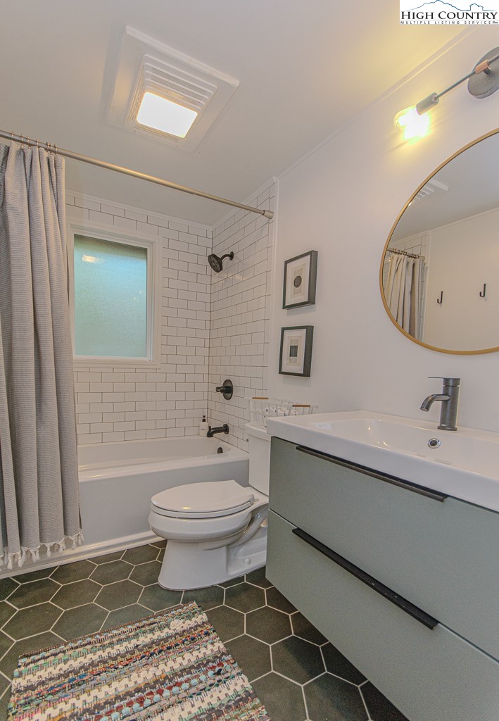 205 Spring Branch Road Beech Mountain, NC 28604 - Photo 22 of 46 a bathroom with a sink toilet a mirror and shower