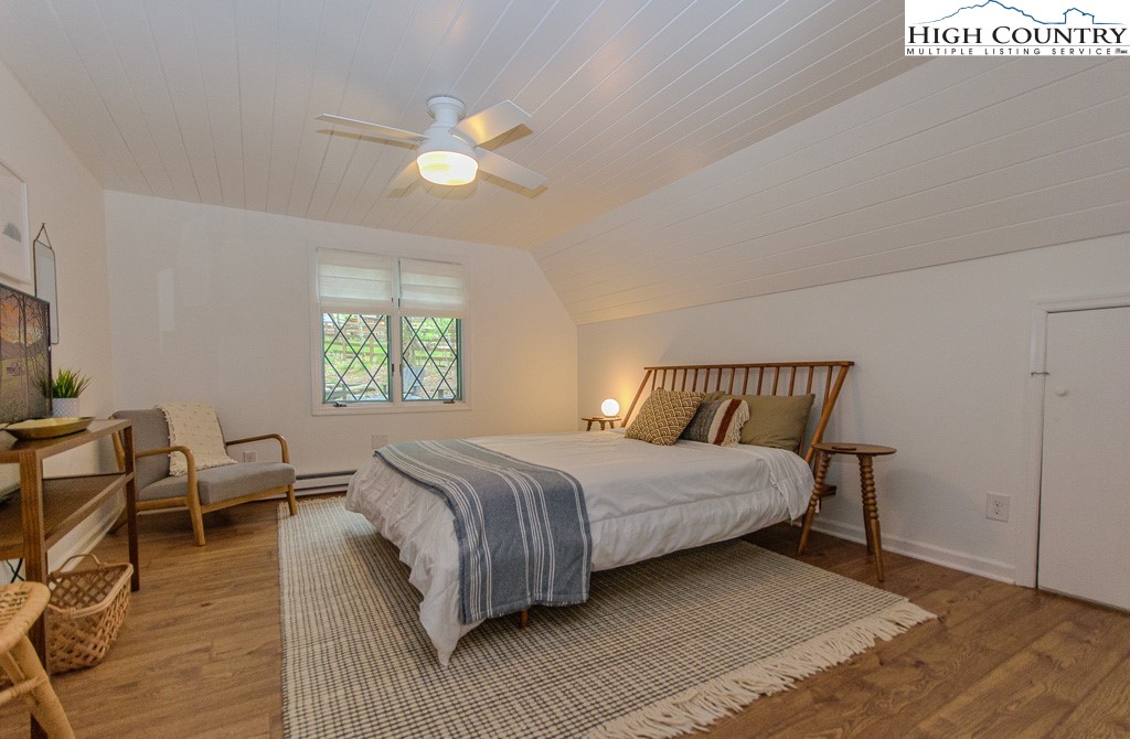 205 Spring Branch Road Beech Mountain, NC 28604 - Photo 23 of 46 a bedroom with a bed and wooden floor