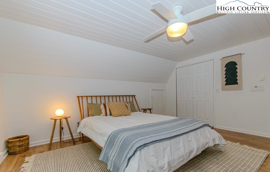 205 Spring Branch Road Beech Mountain, NC 28604 - Photo 25 of 46 a bedroom with a bed and a chandelier