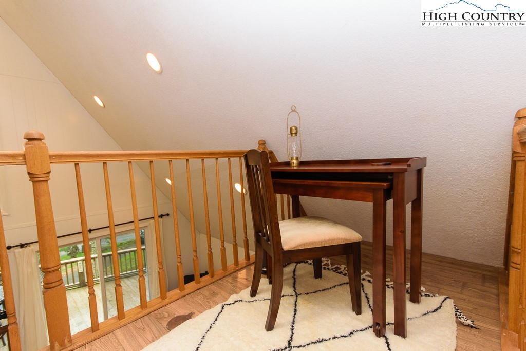 205 Spring Branch Road Beech Mountain, NC 28604 - Photo 32 of 46 a view of a hallway with wooden floor and chair