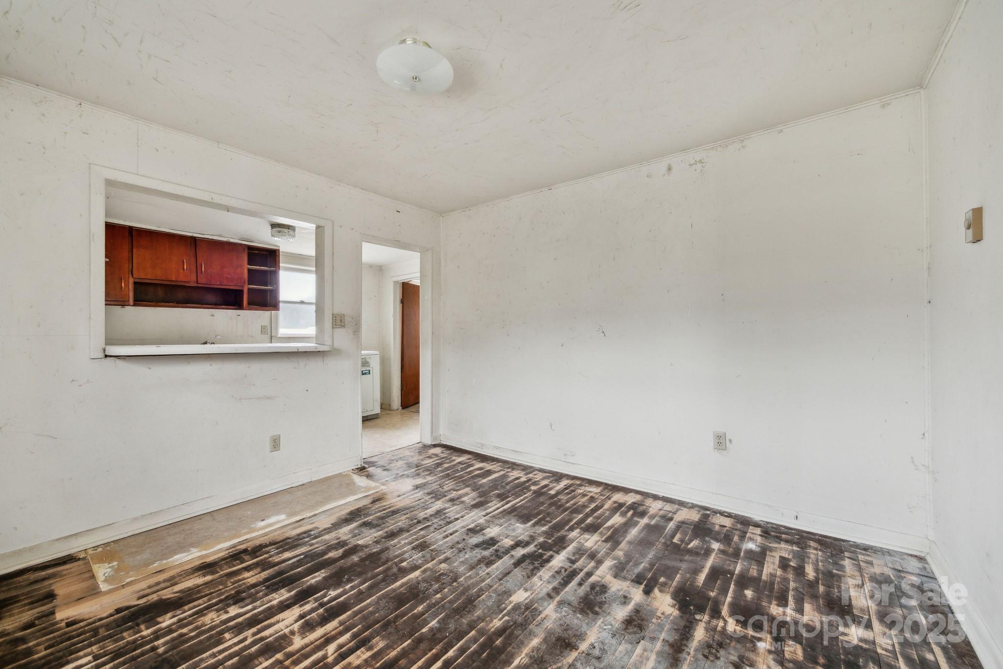 364 Browning Road Waynesville, NC 28786 - Photo 12 of 29 a view of a livingroom with wooden floor and a flat screen tv