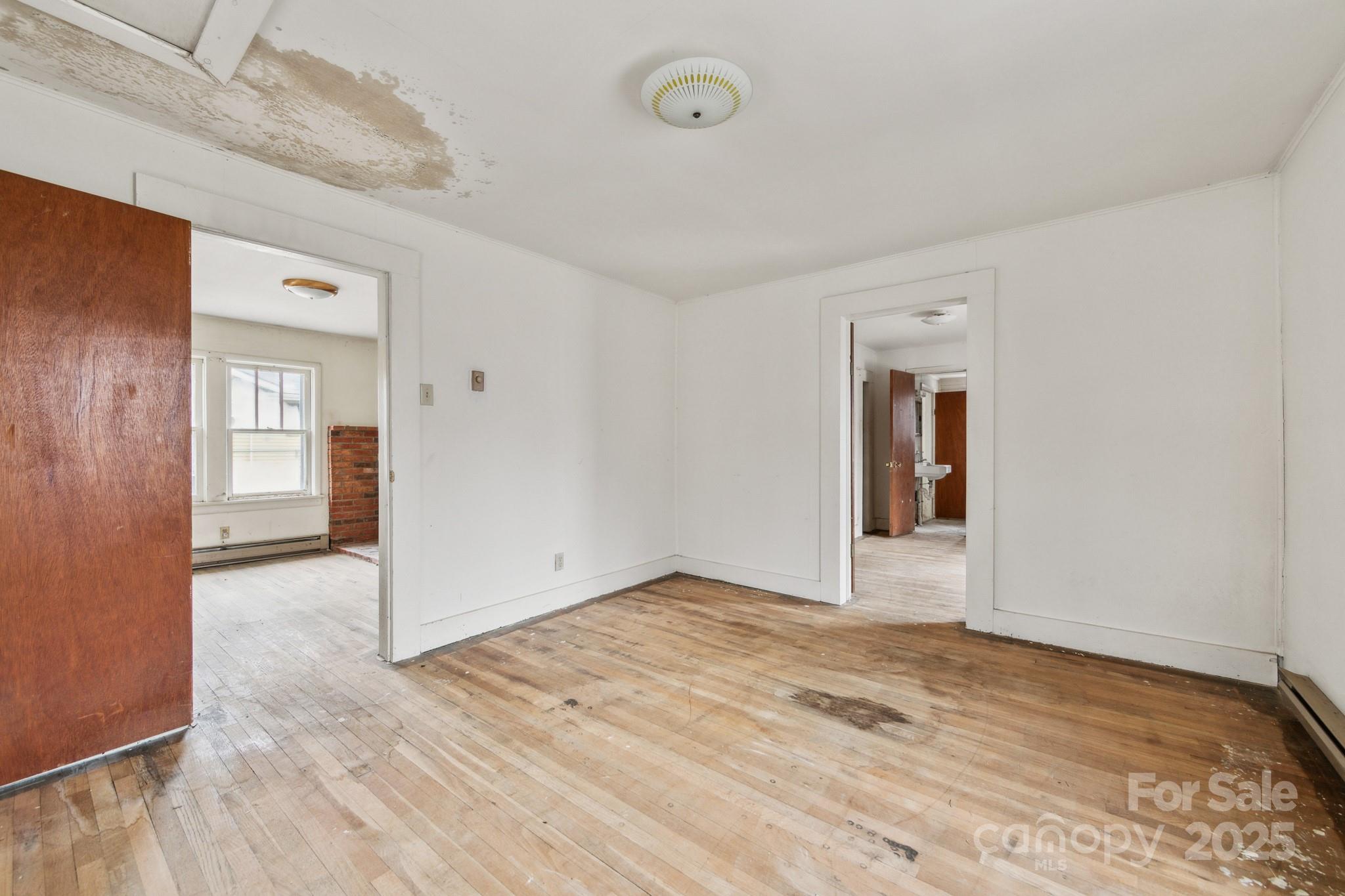 364 Browning Road Waynesville, NC 28786 - Photo 24 of 29 an empty room with wooden floor and windows