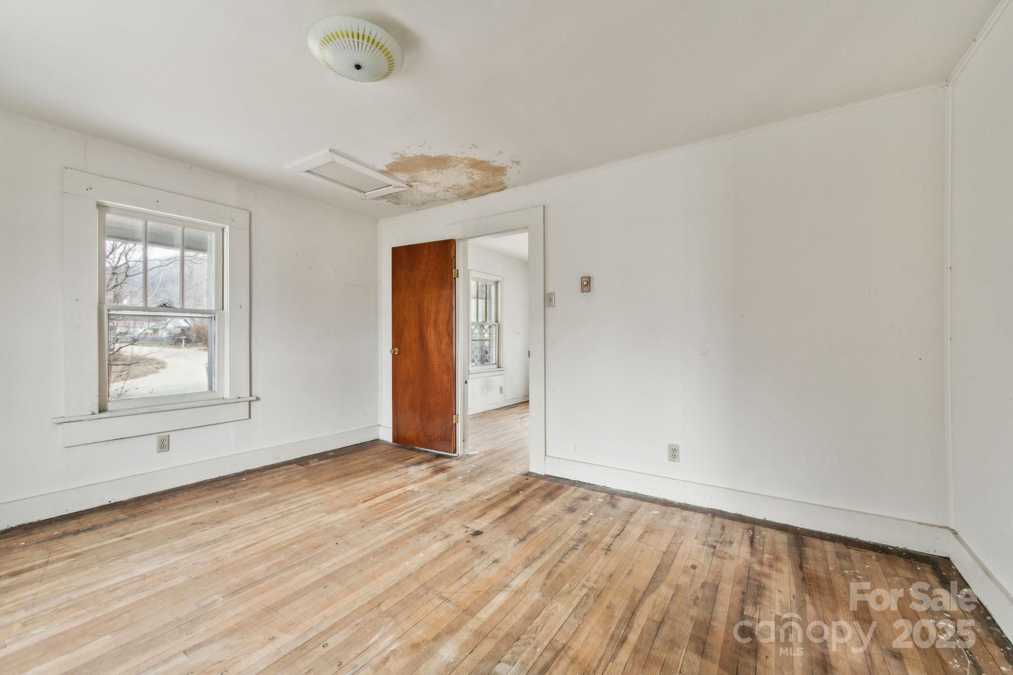 364 Browning Road Waynesville, NC 28786 - Photo 25 of 29 an empty room with wooden floor and windows