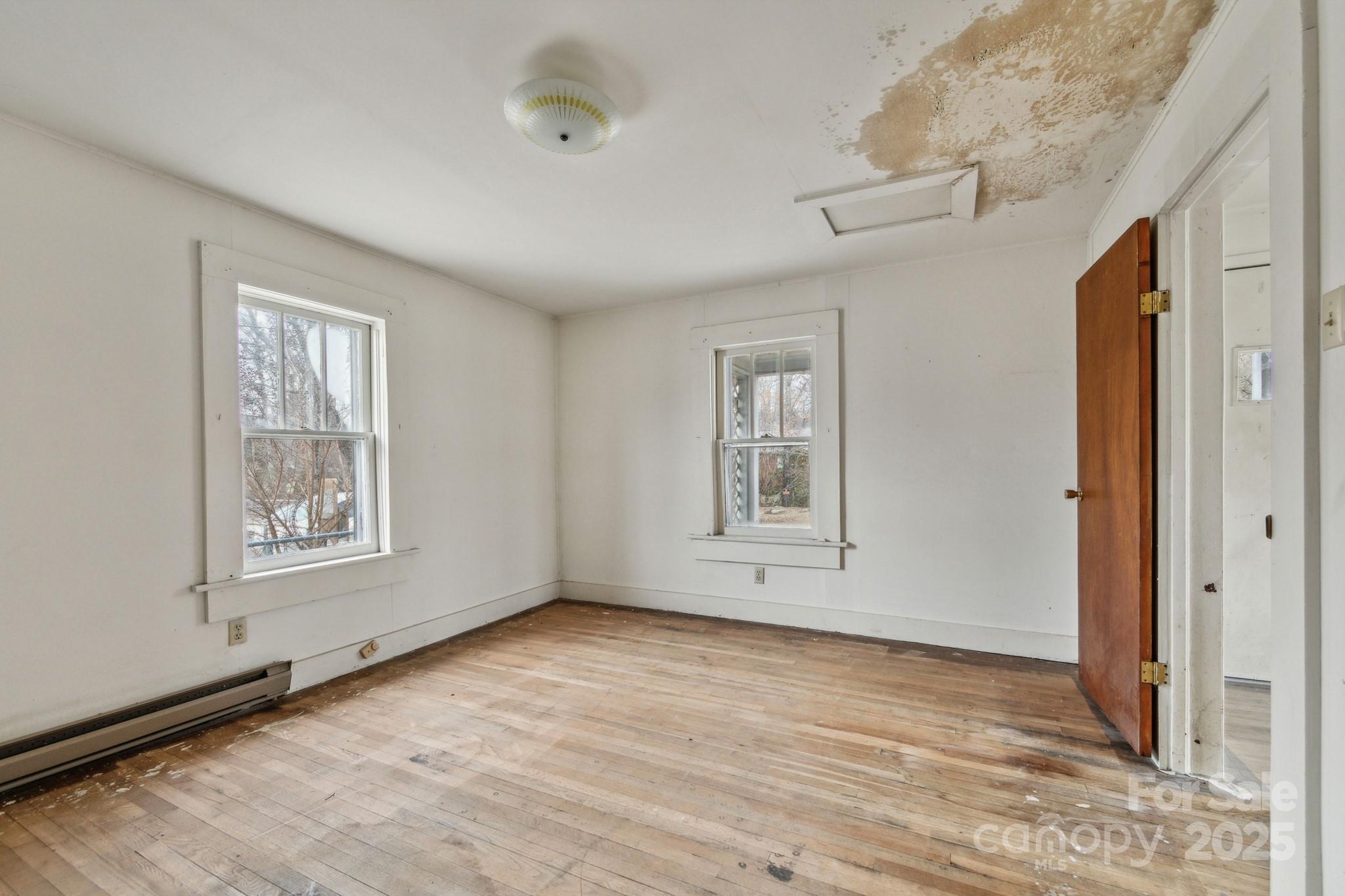 364 Browning Road Waynesville, NC 28786 - Photo 26 of 29 a view of an empty room with wooden floor and a window