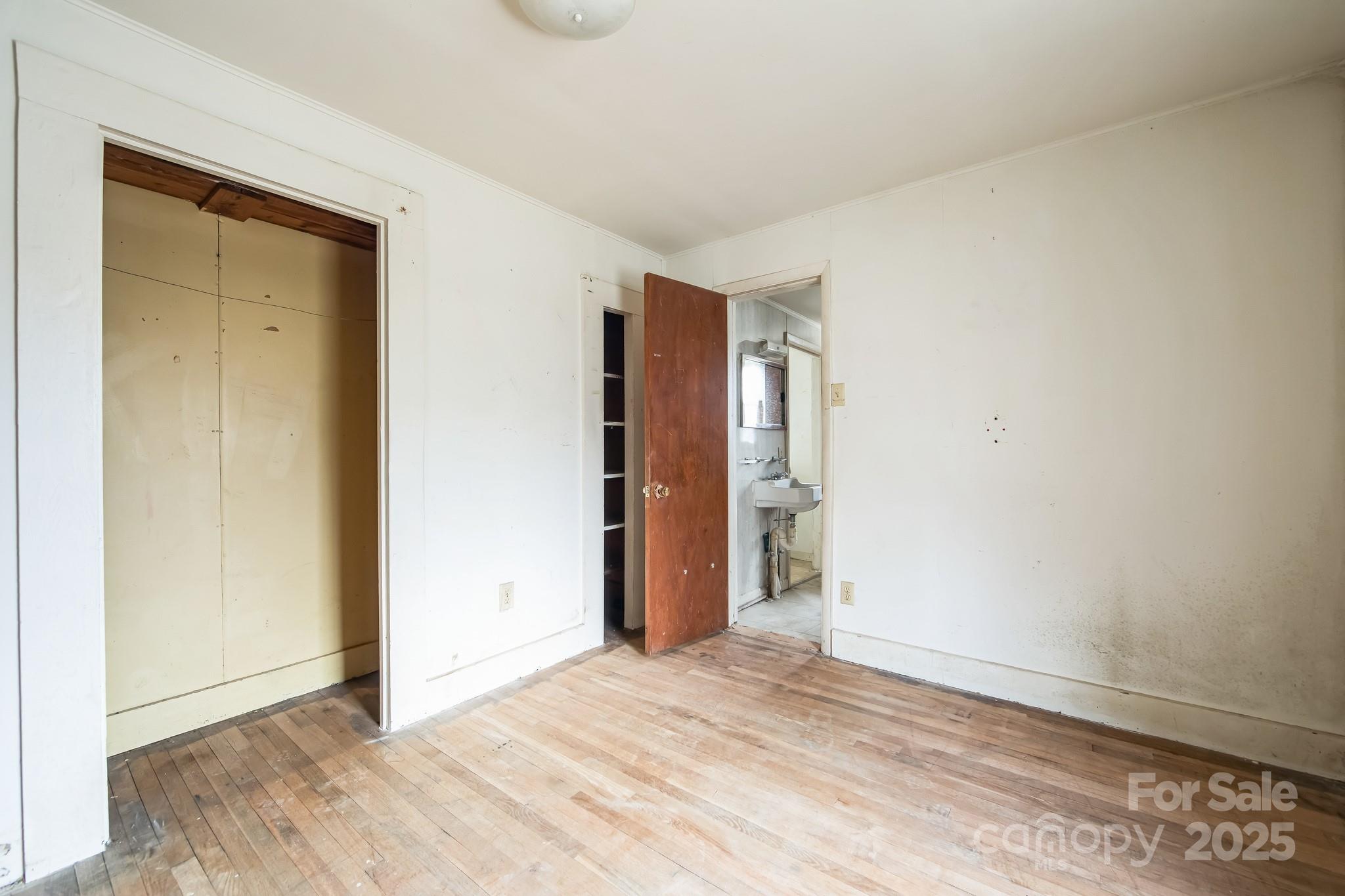 364 Browning Road Waynesville, NC 28786 - Photo 27 of 29 an empty room with wooden floor and closet