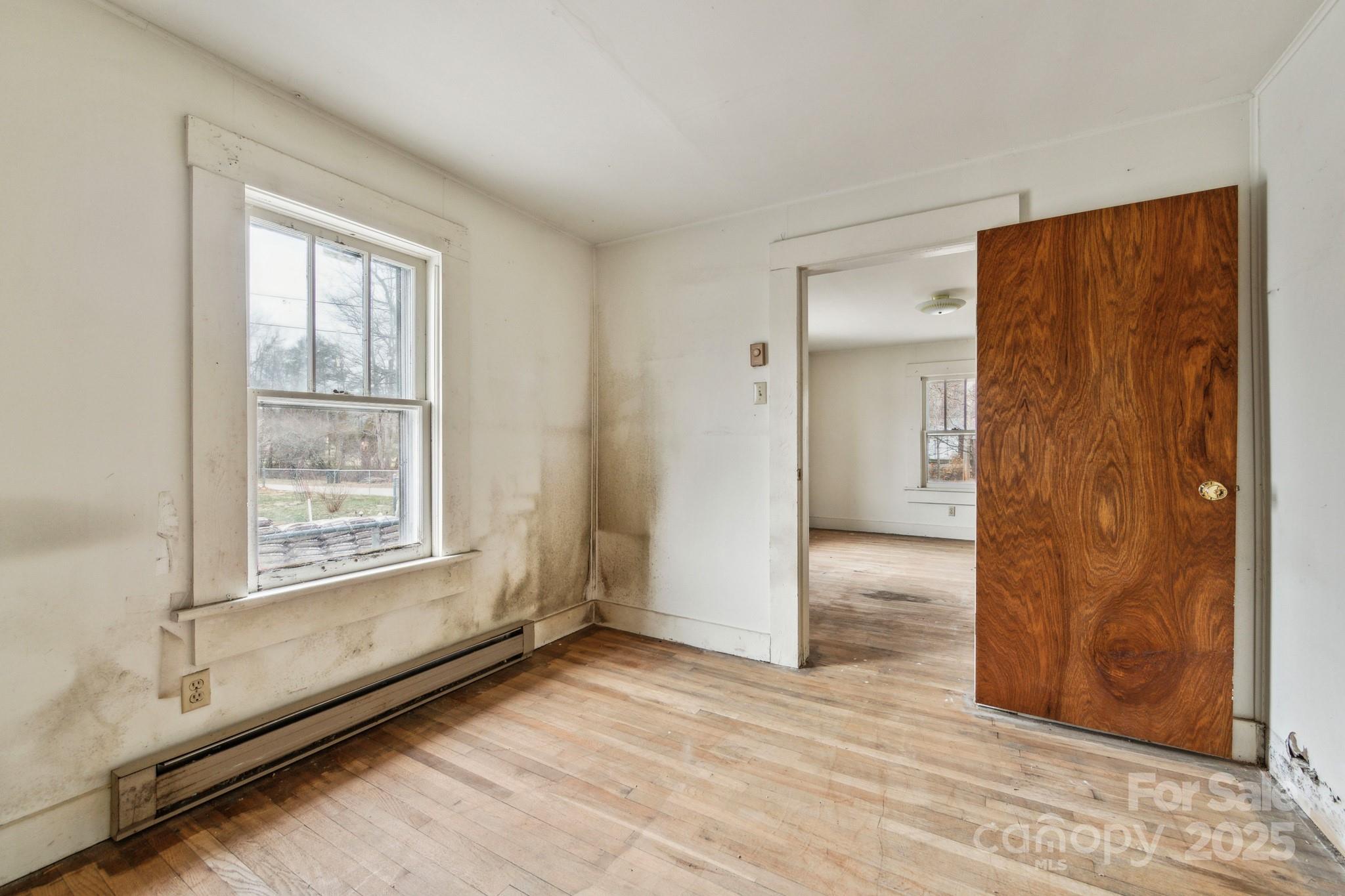 364 Browning Road Waynesville, NC 28786 - Photo 29 of 29 a view of an empty room with wooden floor and a window