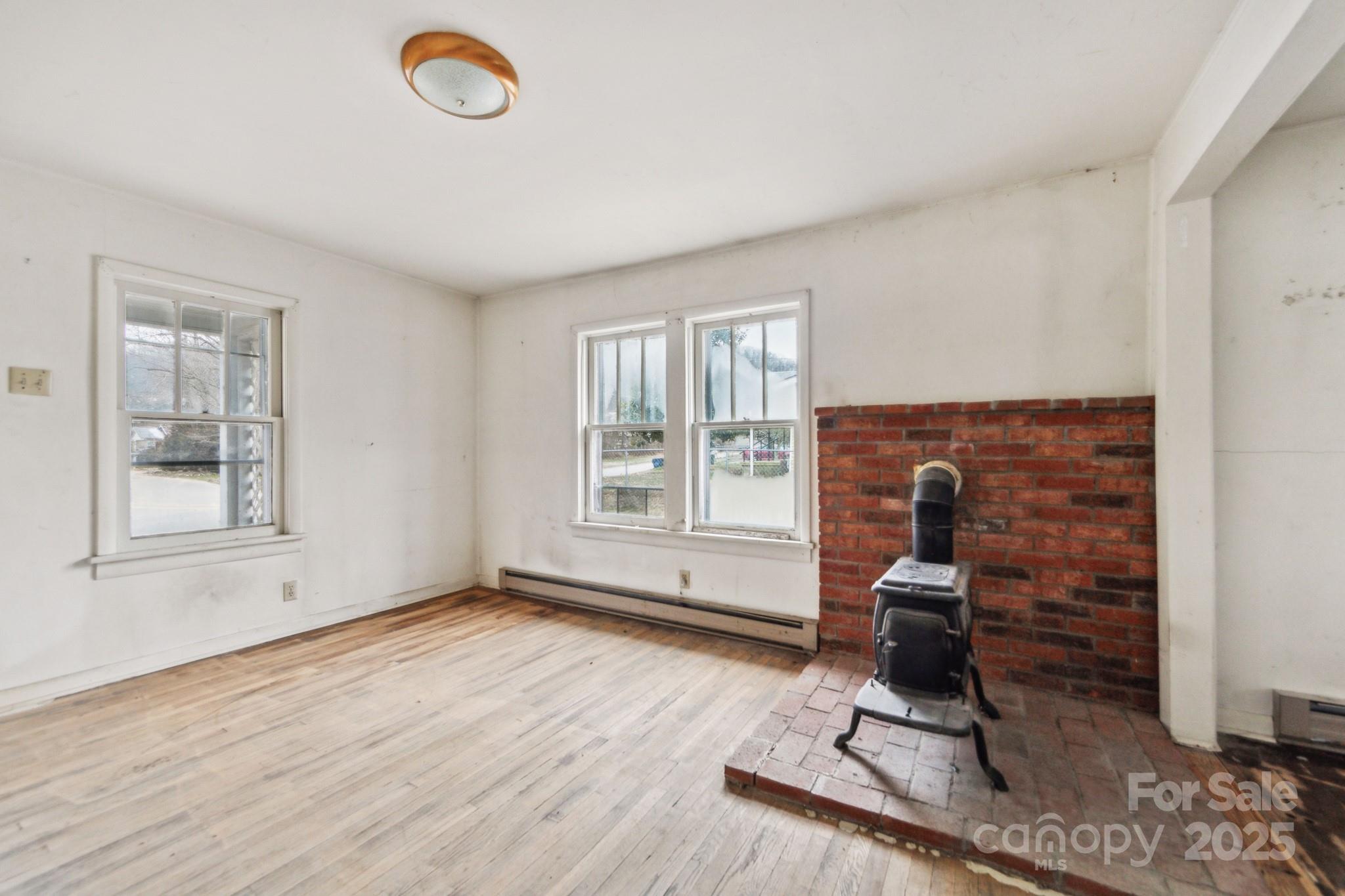 364 Browning Road Waynesville, NC 28786 - Photo 8 of 29 a view of workspace with a window and wooden floor