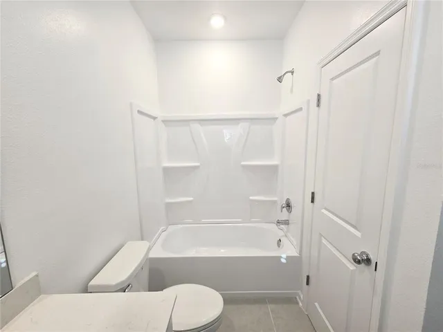 a bathroom with a toilet and a bathtub