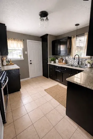 a kitchen with stainless steel appliances kitchen island granite countertop a sink and cabinets