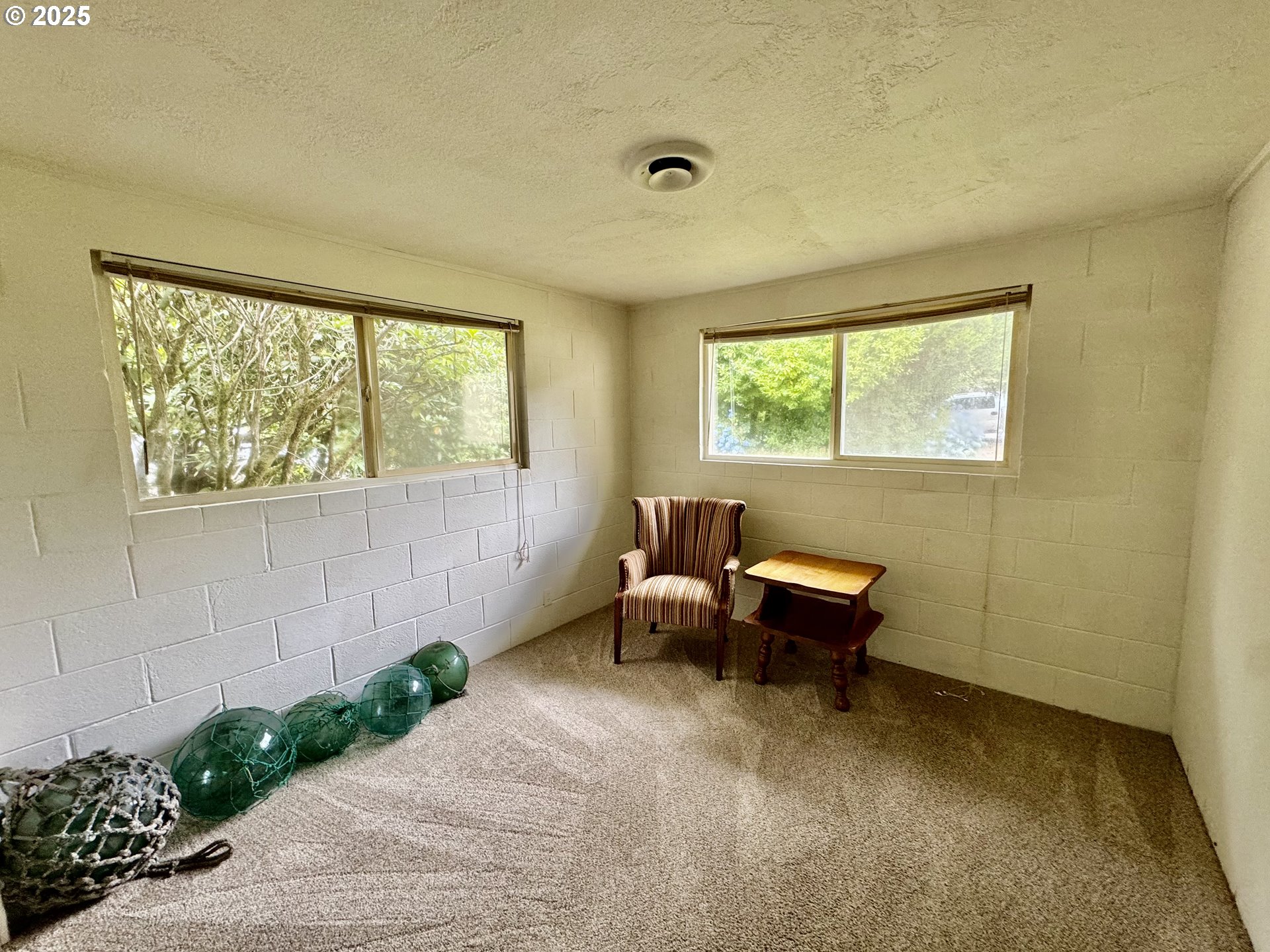 4990 Mitchell Loop Road Florence, OR 97439 - Photo 26 of 37 a living room with furniture and a window