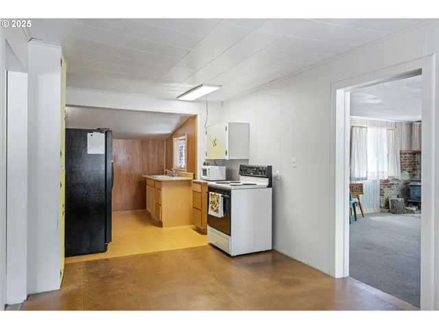 a kitchen with refrigerator and cabinets