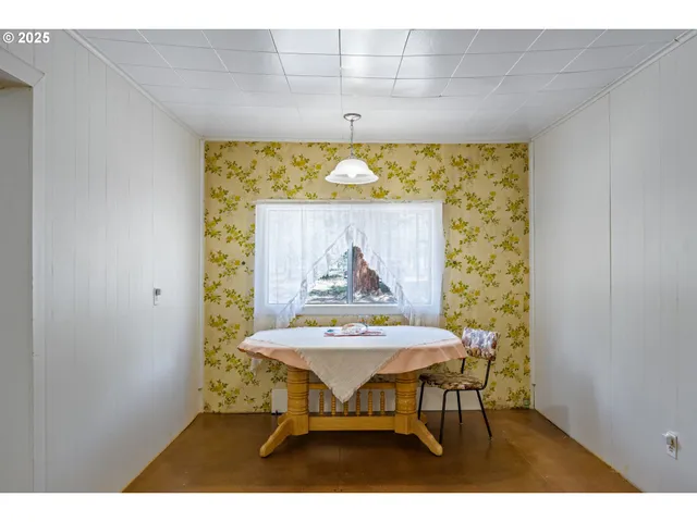 a dining room with a table and chairs