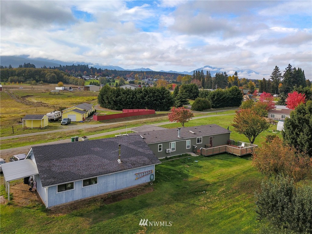 411 Spencer Road Sequim, WA 98382 - Photo 1 of 40 an aerial view of a house with garden space and ocean view
