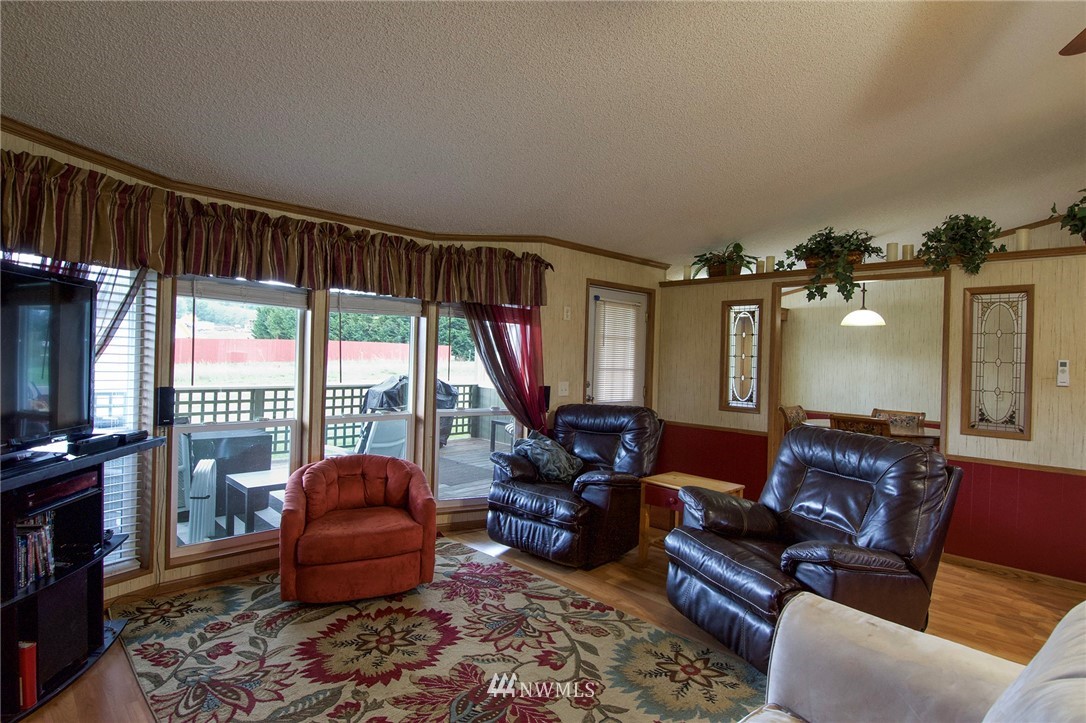 411 Spencer Road Sequim, WA 98382 - Photo 14 of 40 a living room with furniture and a flat screen tv