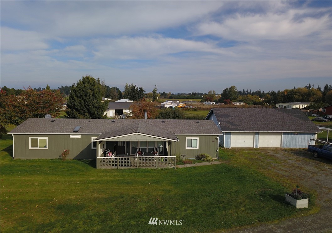 411 Spencer Road Sequim, WA 98382 - Photo 3 of 40 a front view of a house with a garden