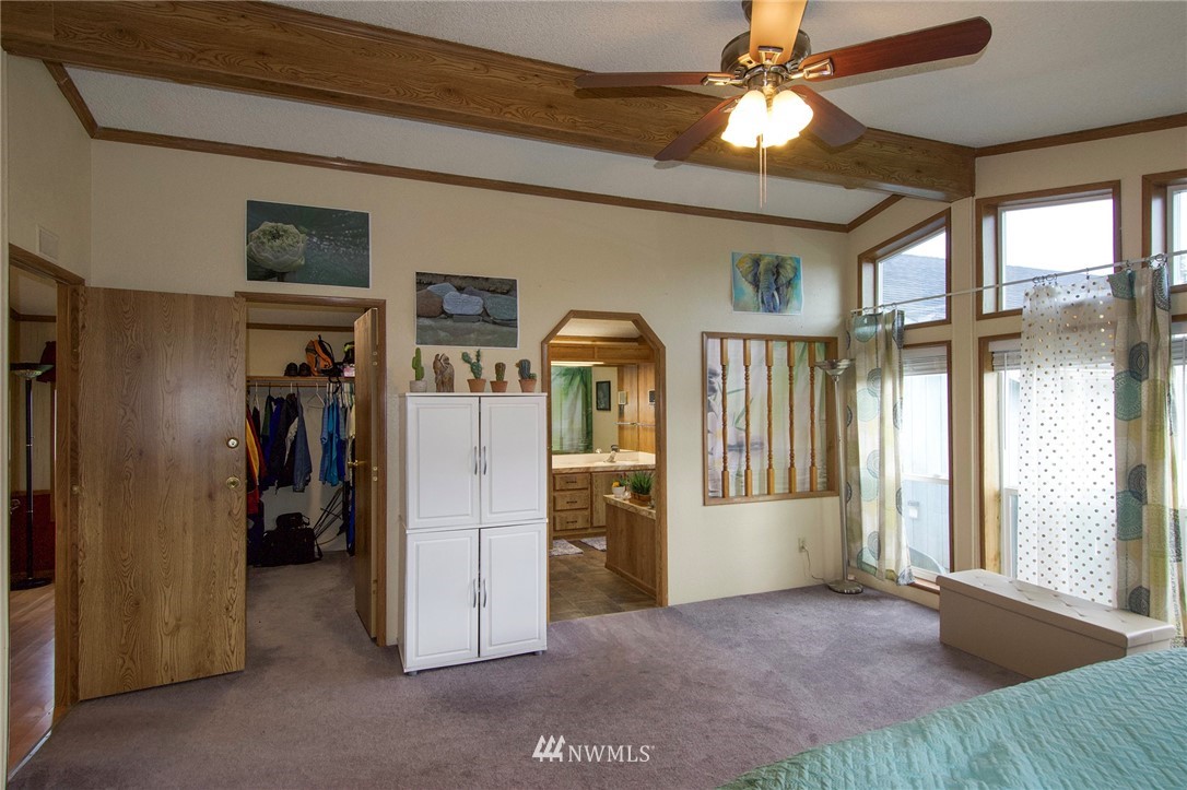 411 Spencer Road Sequim, WA 98382 - Photo 23 of 40 a view of empty room with a ceiling fan