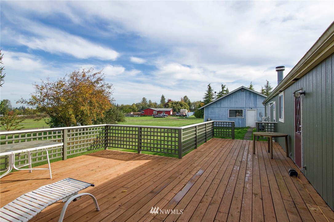 411 Spencer Road Sequim, WA 98382 - Photo 34 of 40 a view of a roof deck with wooden floor and fence