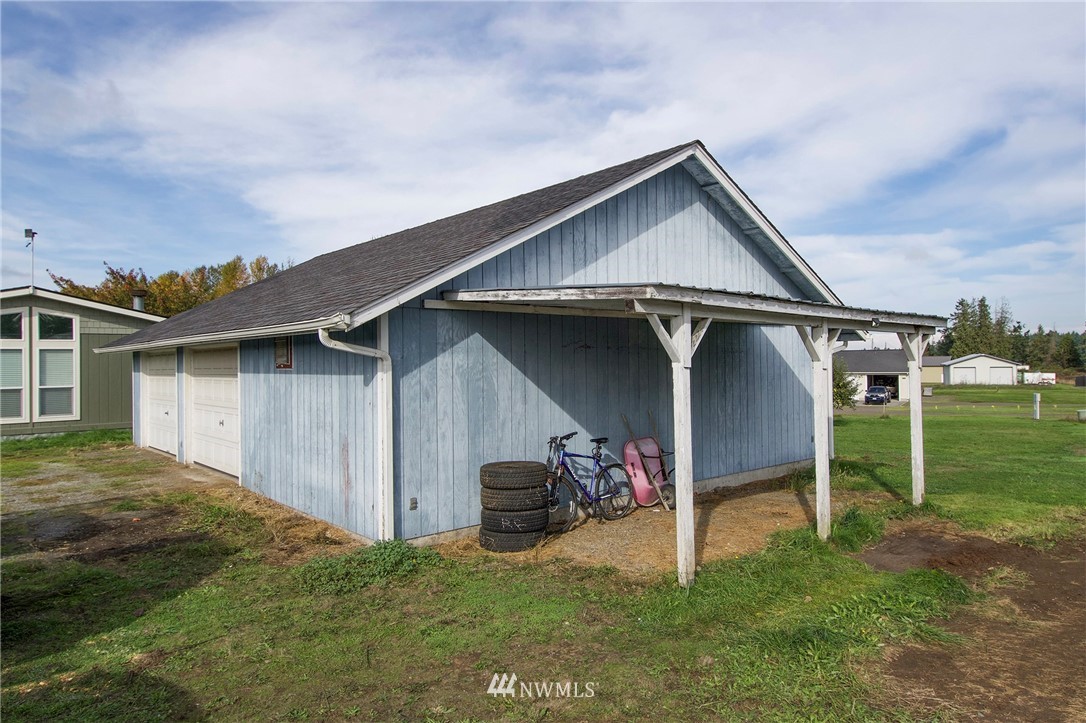 411 Spencer Road Sequim, WA 98382 - Photo 36 of 40 a view of a house with a yard and plants