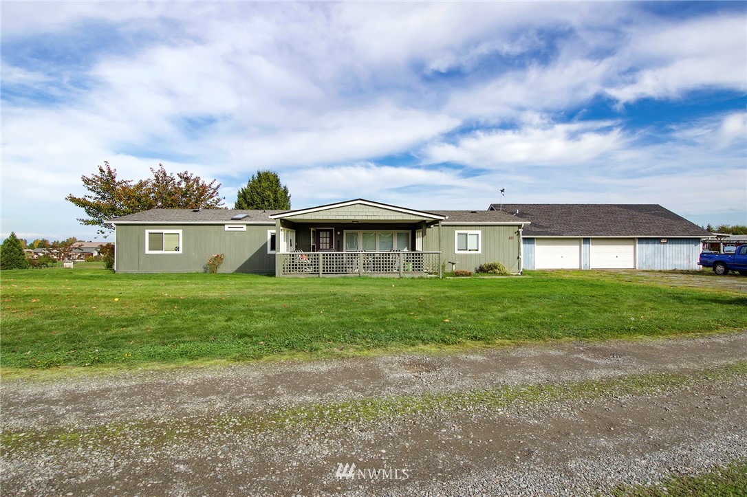 411 Spencer Road Sequim, WA 98382 - Photo 40 of 40 a front view of a house with a garden