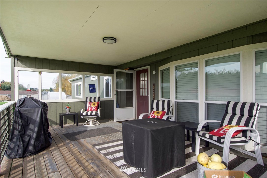 411 Spencer Road Sequim, WA 98382 - Photo 8 of 40 a living room with furniture and a floor to ceiling window